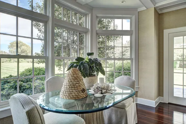 a kitchen with stainless steel appliances granite countertop a stove a sink dishwasher a microwave oven and a refrigerator with wooden floor