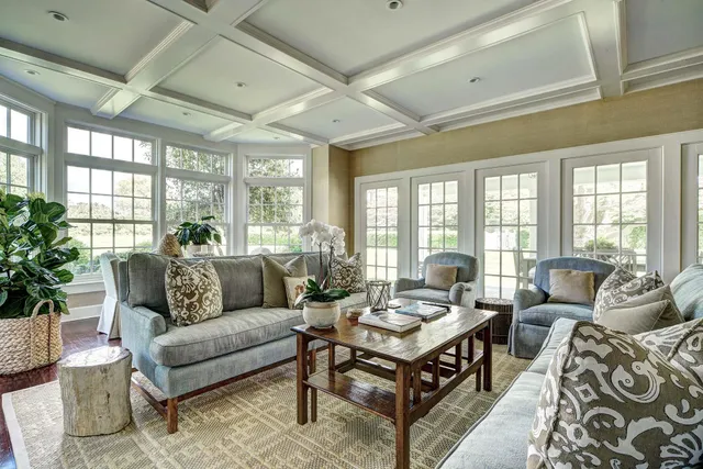 a dining room with furniture wooden floor and glass windows