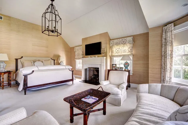 a dining room with furniture a chandelier and window
