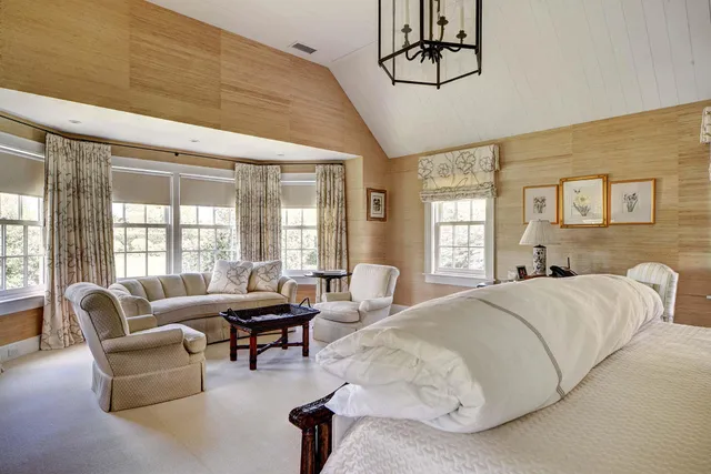 a bedroom with a bed wooden floor and a fireplace