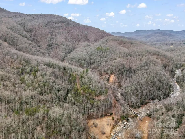 a view of a dry yard with mountains in the background