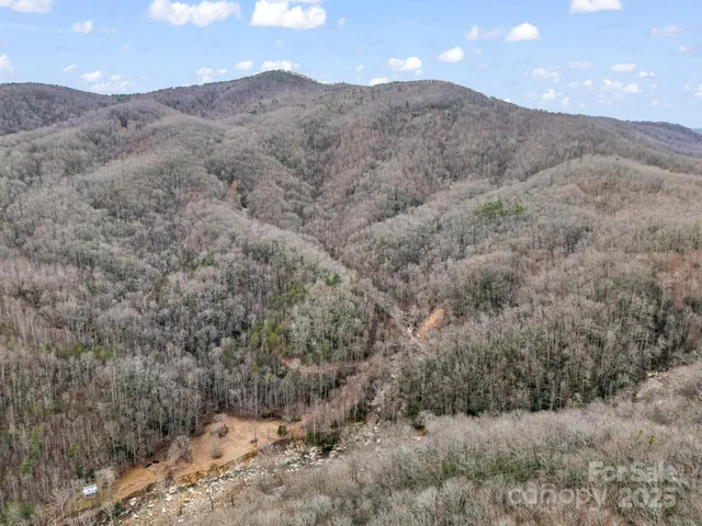 a view of a dry yard with mountains in the background