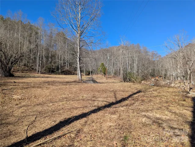 a view of dirt yard with mountain view