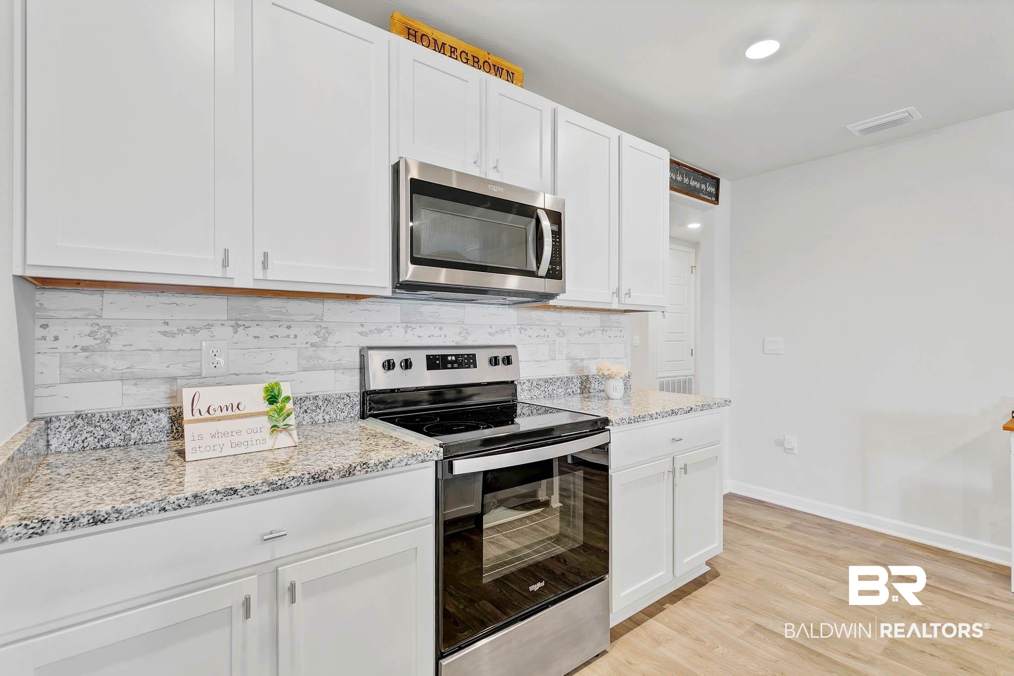 17217 REFLECTION Street Loxley, AL 36551 - Photo 15 of 83 Kitchen with appliances with stainless steel finishes, tasteful backsplash, white cabinetry, and light stone countertops