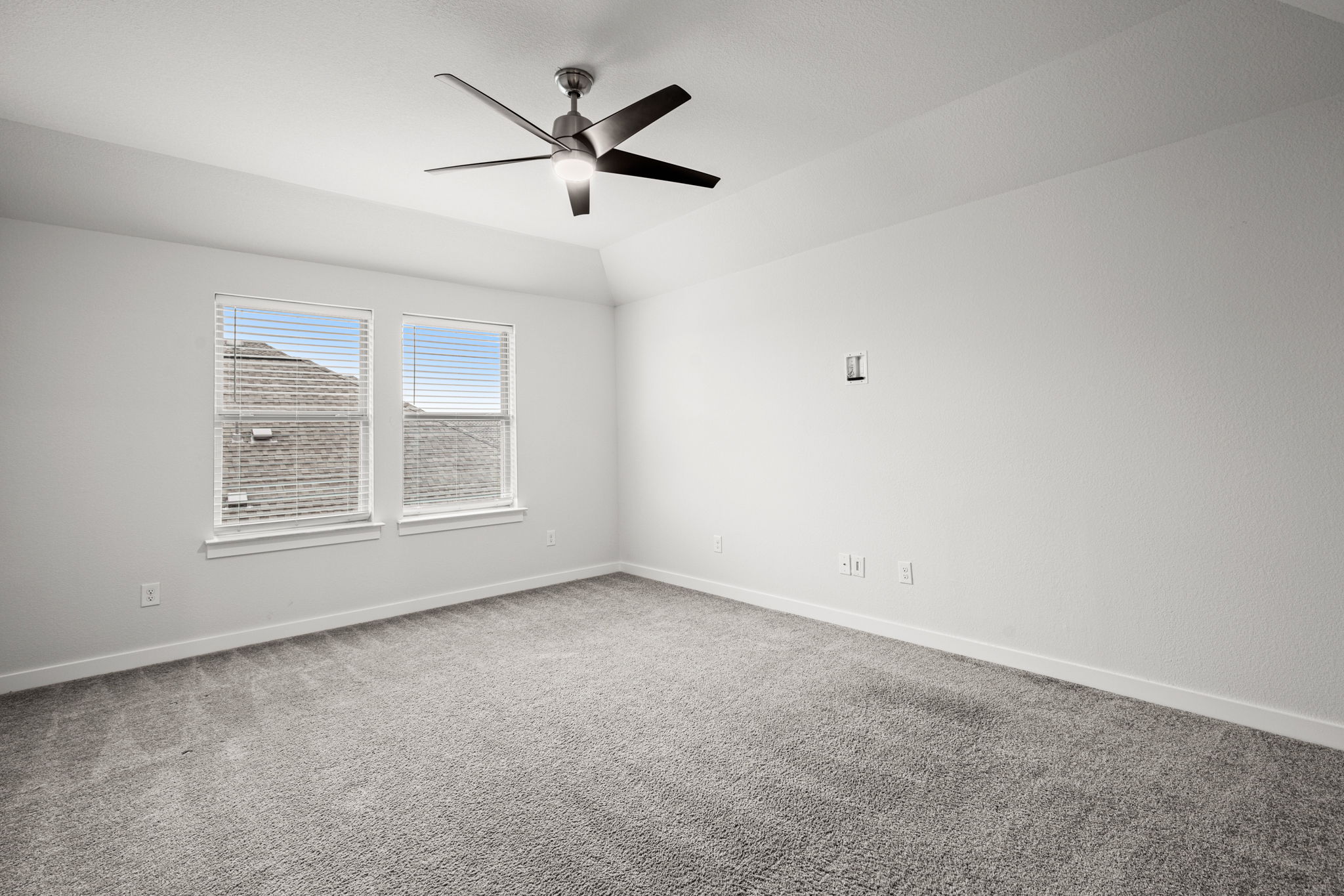 841 Spinnaker Loop Kyle, TX 78640 - Photo 28 of 40 Empty room featuring light colored carpet, lofted ceiling, and a ceiling fan