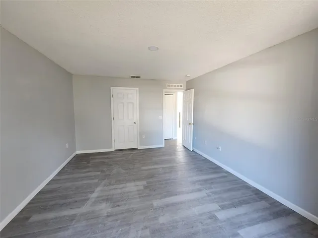 a view of an empty room and wooden floor