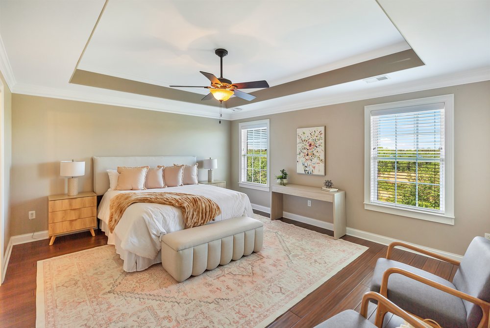 15 Fawn Hill Drive Anderson, SC 29621 - Photo 22 of 38 This tranquil primary bedroom features an elegant tray ceiling and large windows overlooking lush greenery.