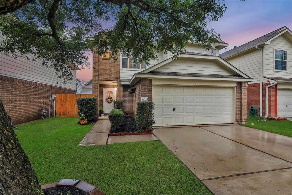 a front view of a house with a yard and garage