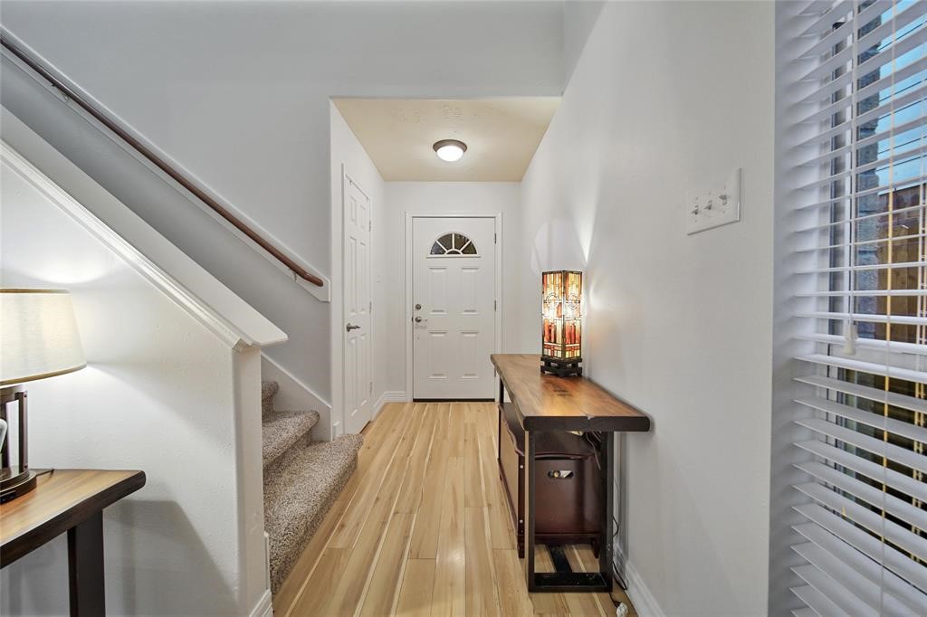 16923 Lockford Lane Houston, TX 77073 - Photo 3 of 7 a view of a hallway with wooden floor and staircase