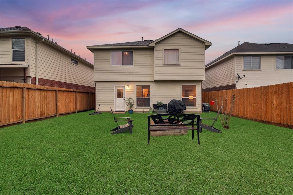 16923 Lockford Lane Houston, TX 77073 - Photo 7 of 7 a view of a backyard with table and chairs wooden fence
