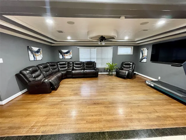 a living room with furniture and a ceiling fan