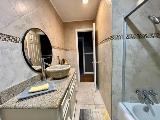 a living room with furniture a chandelier and a dining table