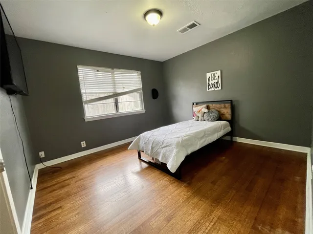 a bedroom with a bed and a table in it