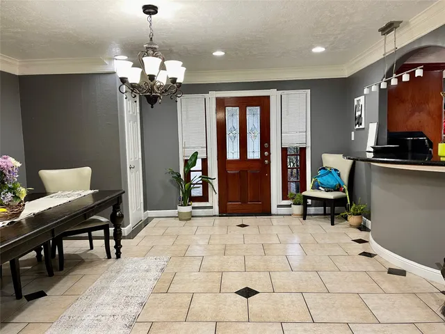 a view of a kitchen with granite countertop a refrigerator and a stove