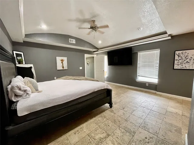 a view of a living room with furniture and flat screen tv
