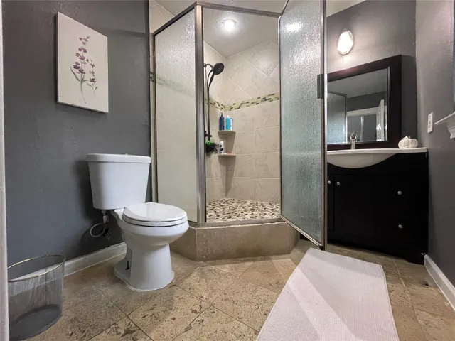 a large kitchen with stainless steel appliances a stove a refrigerator a sink and a stove