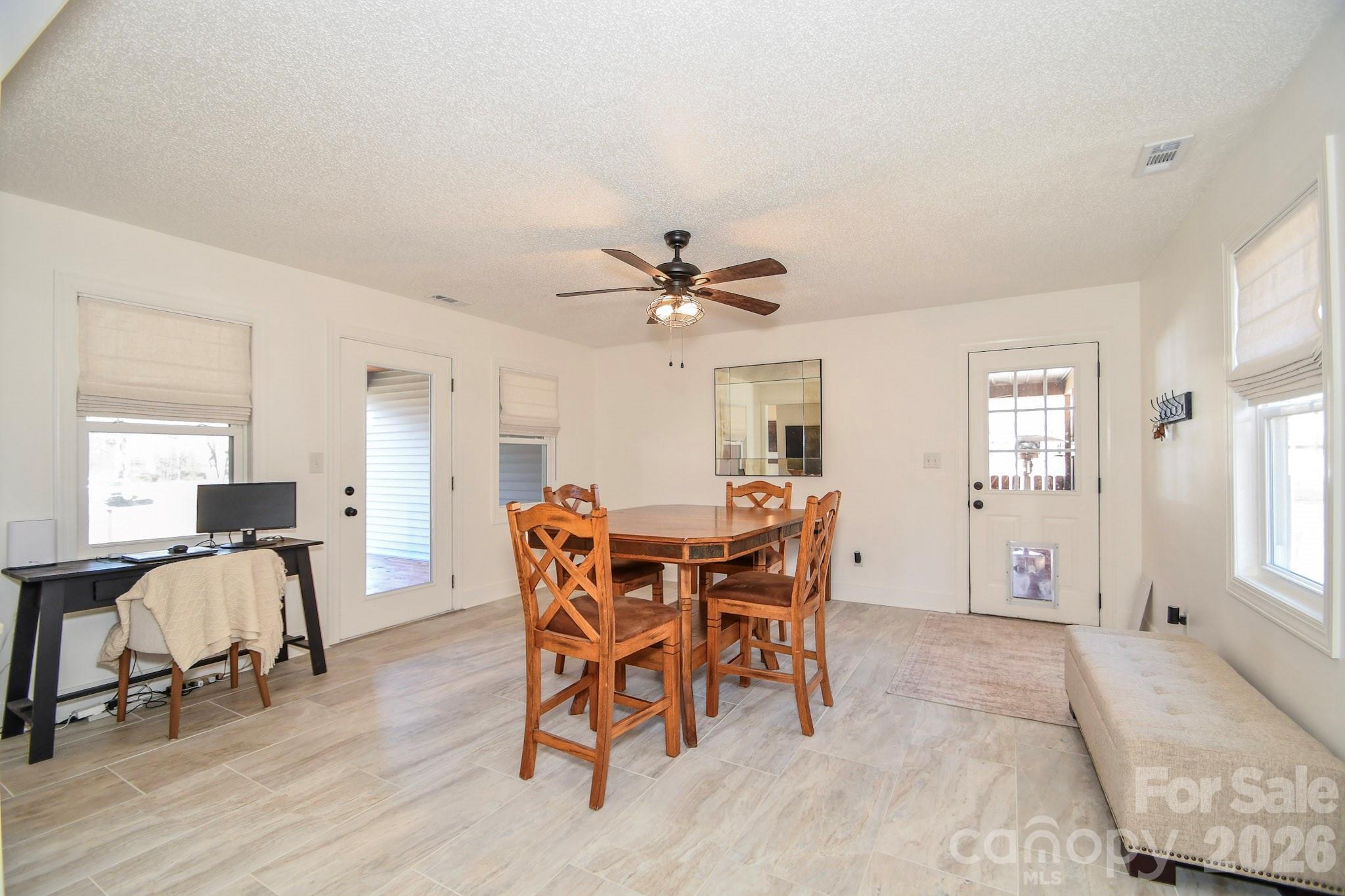 1925 Sojourn Road Marshville, NC 28103 - Photo 27 of 41 a view of a dining room with furniture and wooden floor
