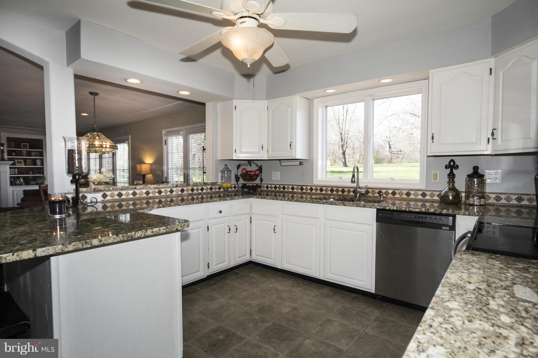 16200 Yeoho Road Sparks, MD 21152 - Photo 11 of 30 a large kitchen with granite countertop a stove sink and cabinets