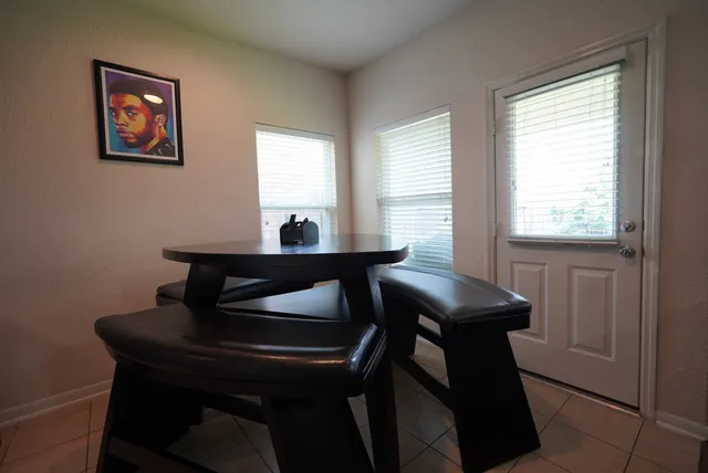 a view of a workspace with furniture and a window