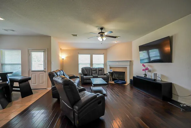 a living room with furniture fireplace and a flat screen tv