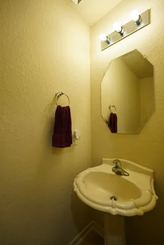 a bathroom with a sink and mirror