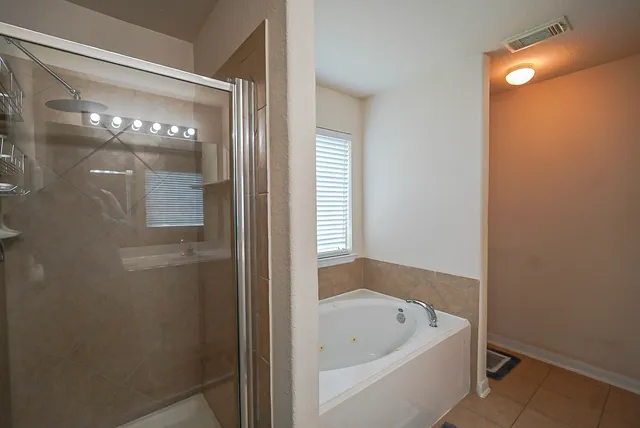 a bathroom with a tub and shower