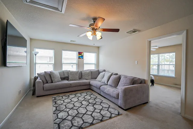 a living room with furniture and a large window