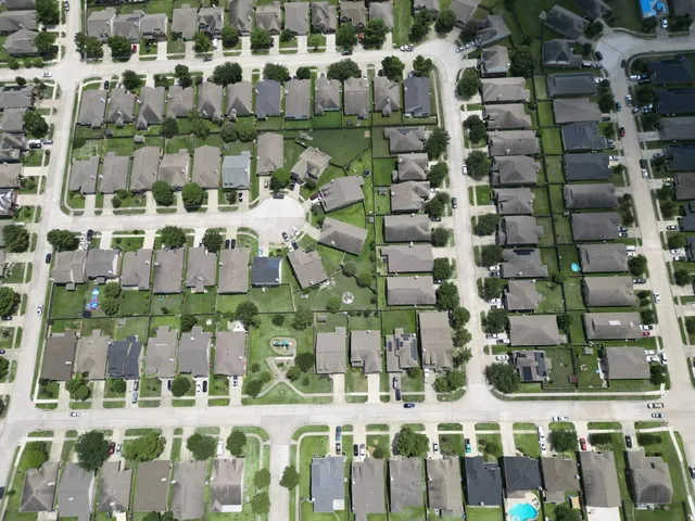 an aerial view of multiple houses with yard