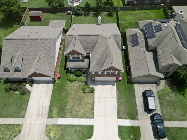 an aerial view of a house with a yard