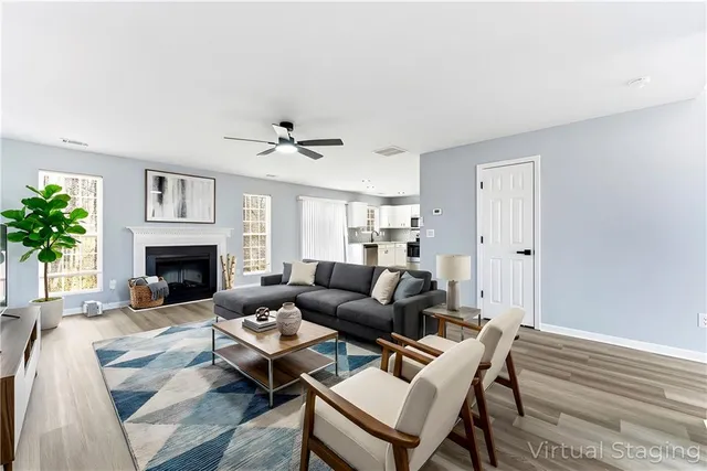 a living room with furniture and a fireplace