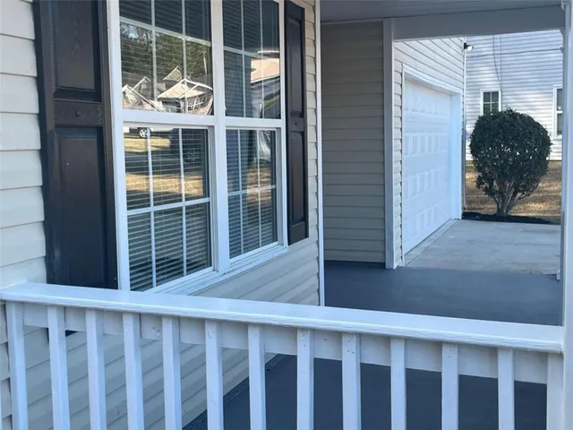 a view of a livingroom with wooden floor and a fireplace