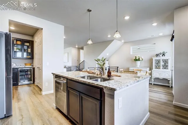 a kitchen with a sink a counter space and stainless steel appliances