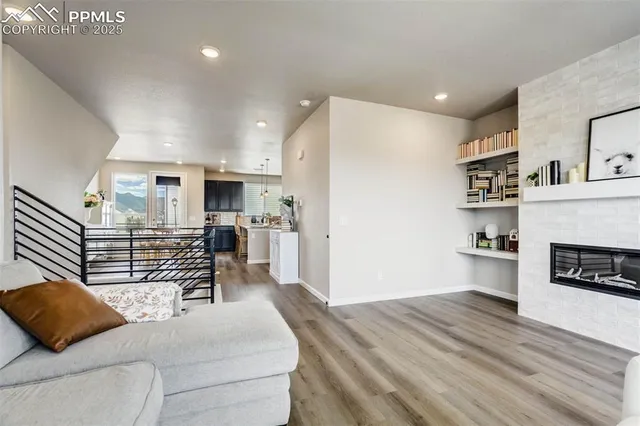 a living room with furniture and wooden floor