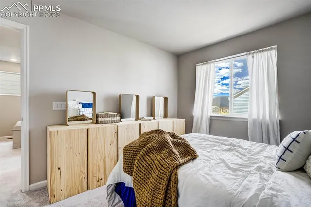 a bedroom with a bed and a dresser in it