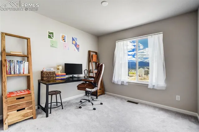 a hallway with two chairs and a large window