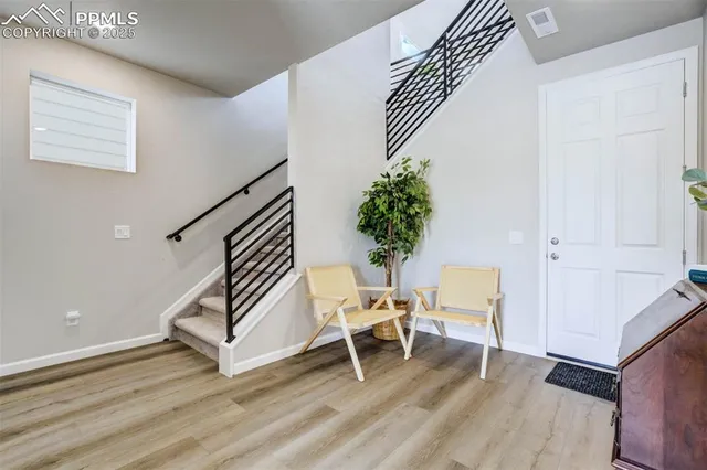 a room with wooden floor and stairs
