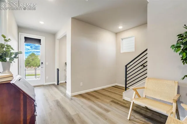 a view of a room with wooden floor and windows
