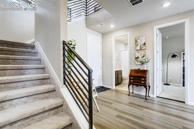 a view of entryway and hall with wooden floor