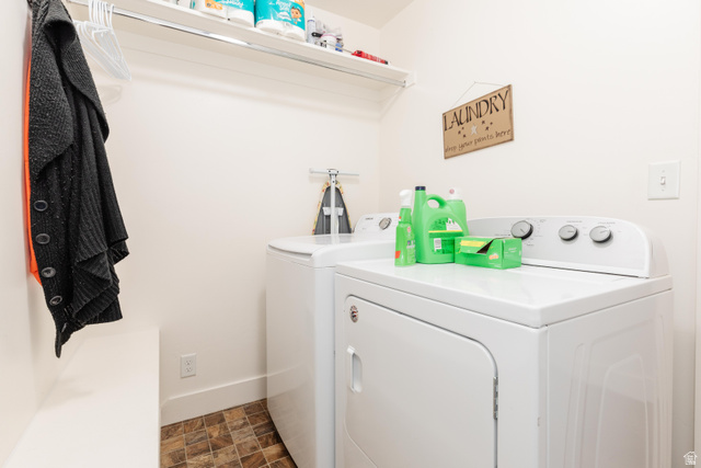 1145 West 2640th Street South Logan, UT 84321 - Photo 13 of 17 Dedicated laundry area featuring a washer and dryer, tile flooring, and overhead shelving