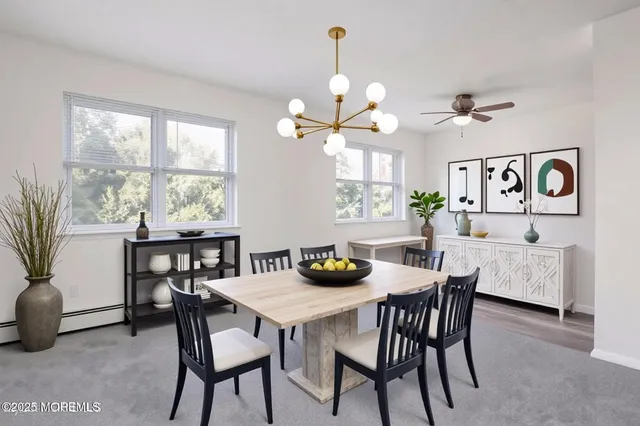 a view of a dining room with furniture and a large window