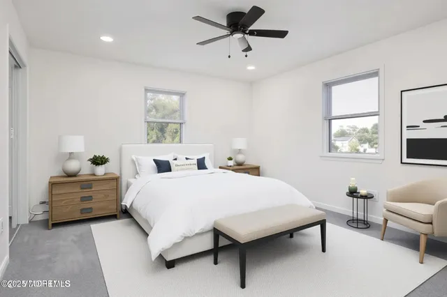 a large bedroom with a bed and a couch