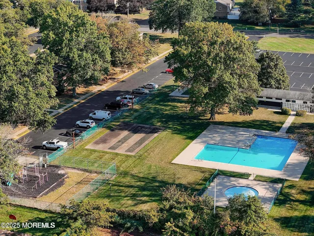 an aerial view of a house with a yard basket ball court and outdoor seating