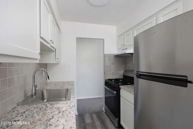a kitchen with a refrigerator and a sink
