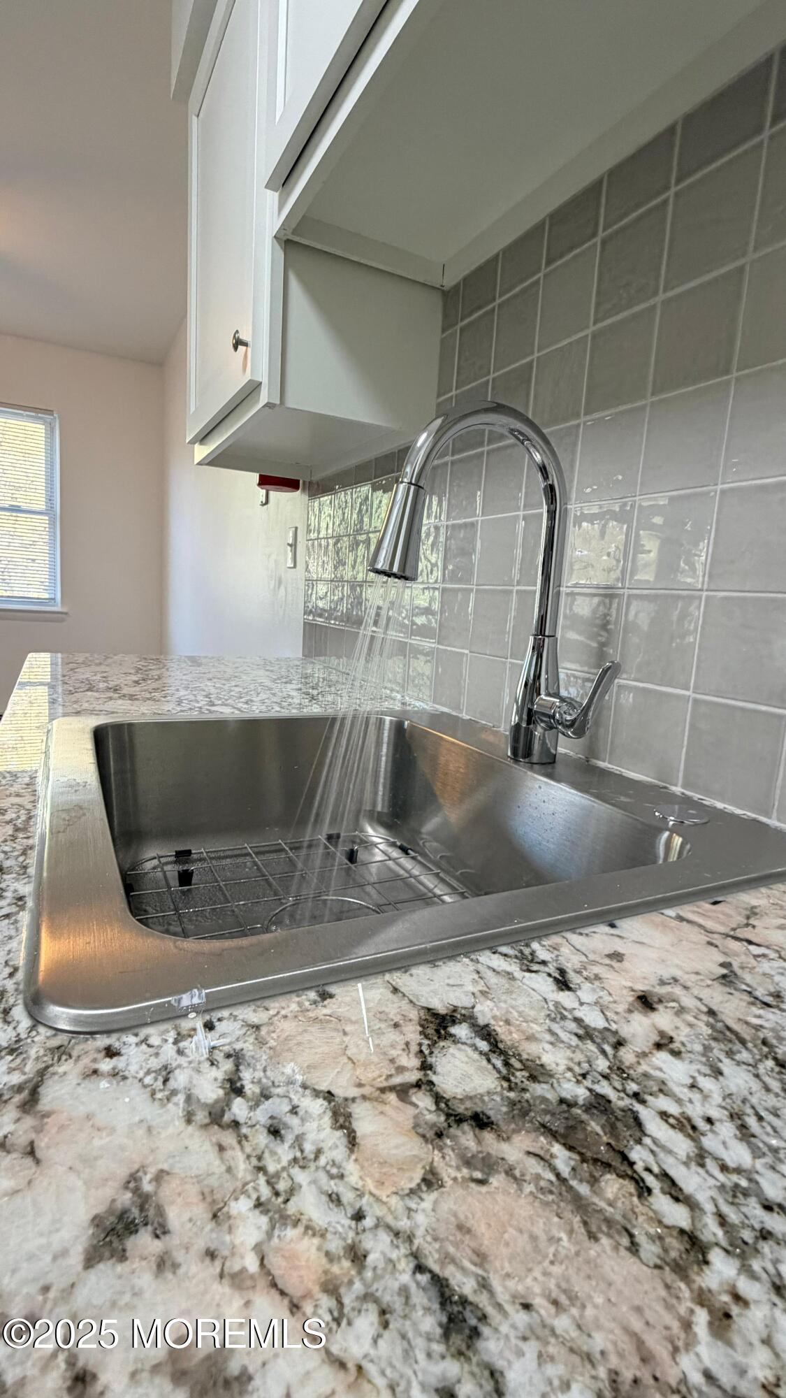 26 Windsor Terrace, Unit G Freehold, NJ 07728 - Photo 6 of 15 a view of a kitchen with a sink and a window