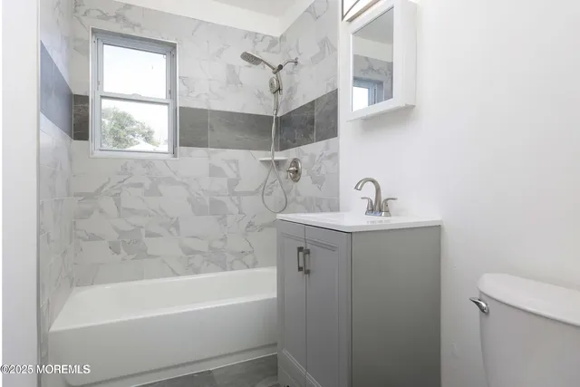 a bathroom with a sink a mirror and a bathtub