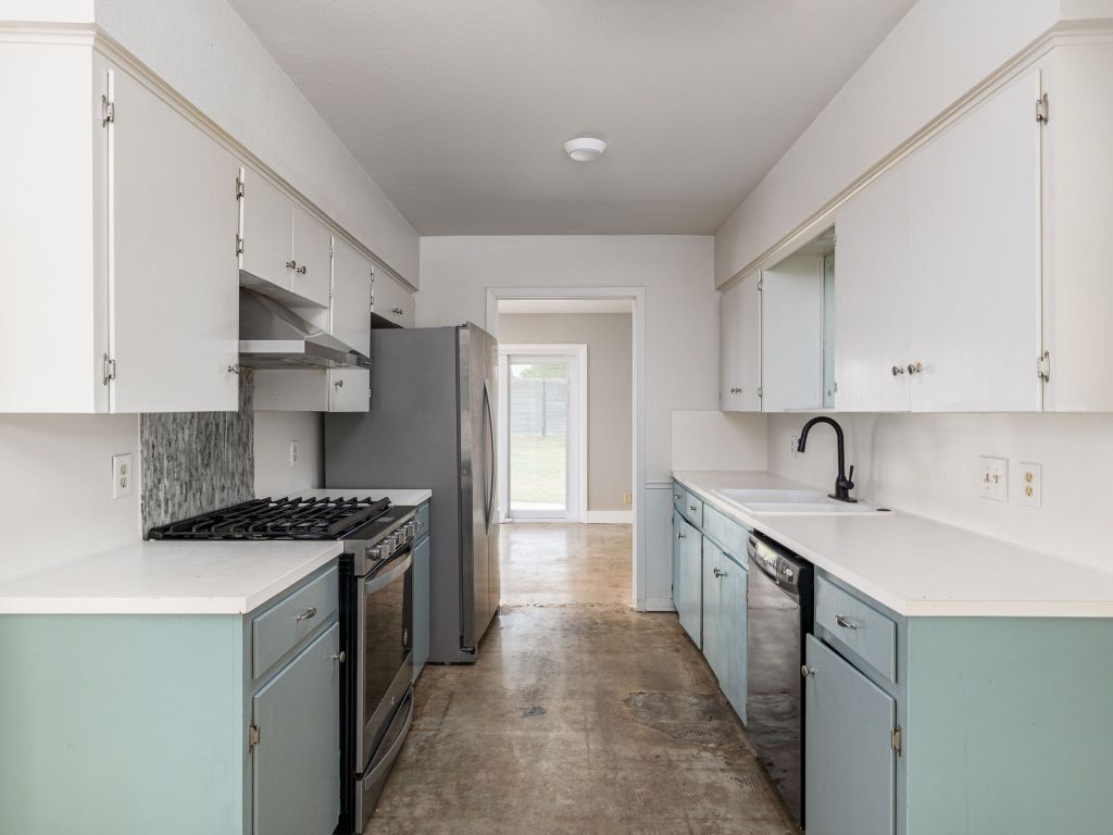 9506 Mountain Quail Road Austin, TX 78758 - Photo 4 of 16 The kitchen has a gas stove, and stainless-steel refrigerator. The concrete floors make for easy clean-up.