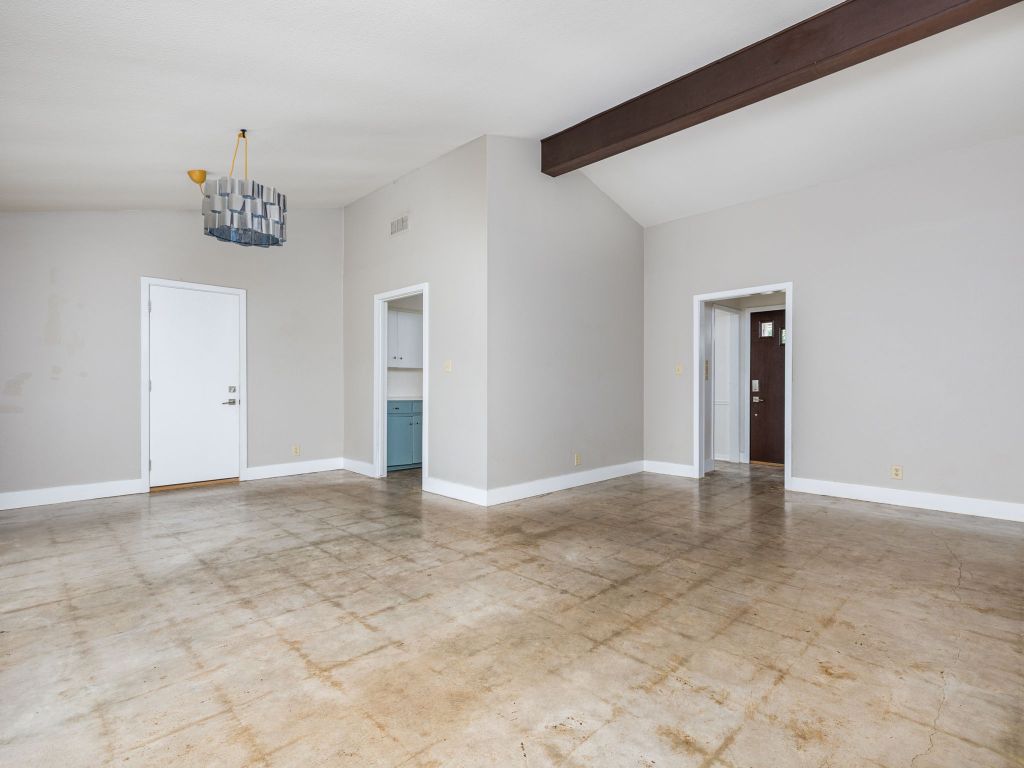 9506 Mountain Quail Road Austin, TX 78758 - Photo 5 of 16 The kitchen door (seen in middle), leads to the formal-dining area, which has high, beam ceilings.