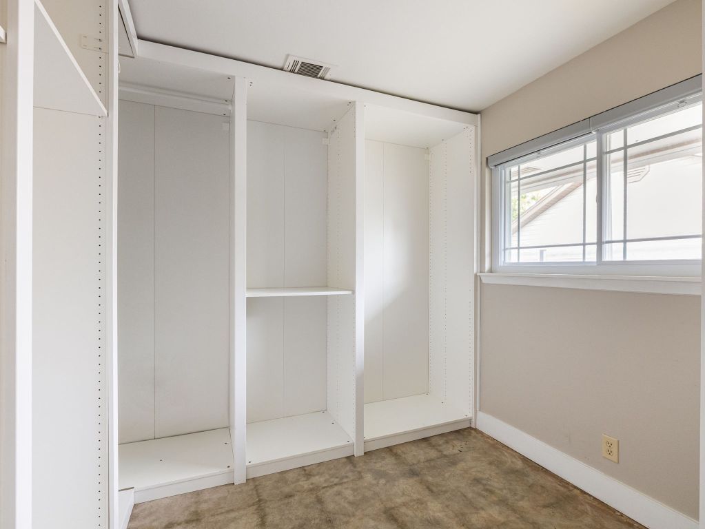 9506 Mountain Quail Road Austin, TX 78758 - Photo 9 of 16 Primary bedroom has a walk-in closet, with a window.