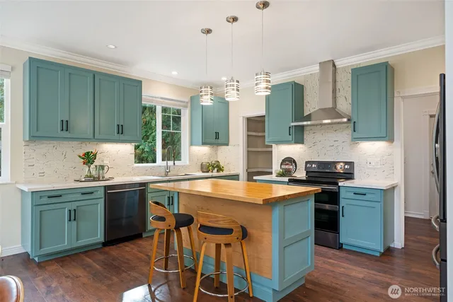 a kitchen with a sink cabinets and wooden floor