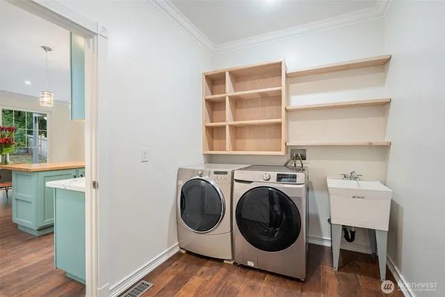a utility room with sink dryer and washer